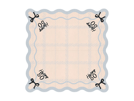 Flat lay of Happy 50 scalloped napkin with pastel plaid pattern and bow detail, ideal for 50th birthday parties.
