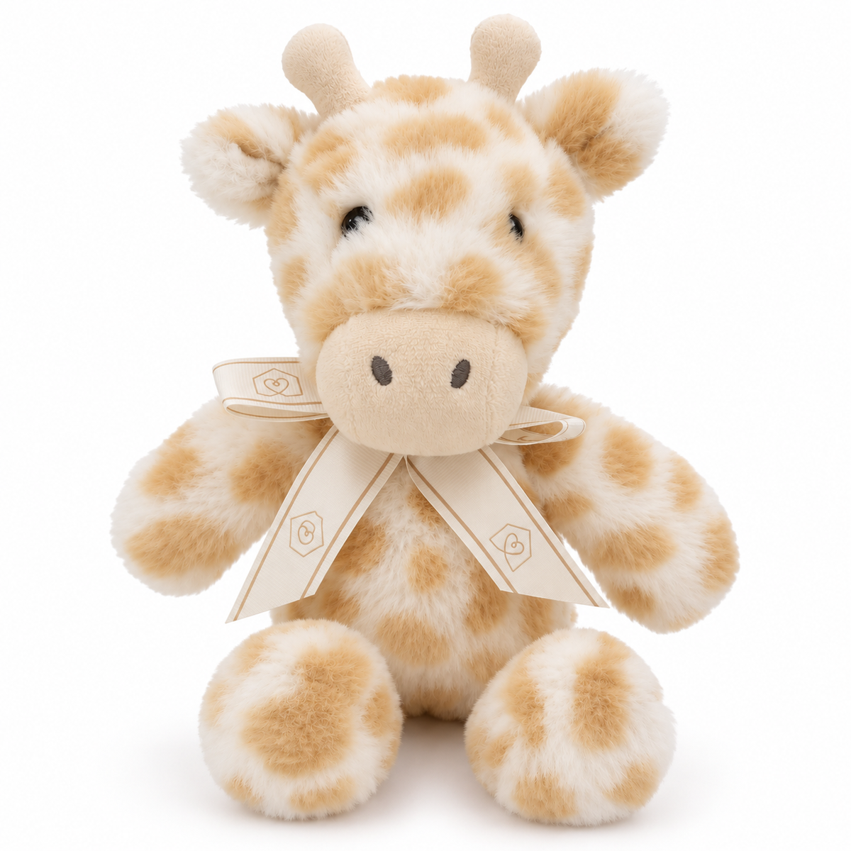 Soft cream and beige spotted giraffe plush toy with embroidered details and a decorative ribbon bow. Pick up in Toronto + Canada-wide shipping available.