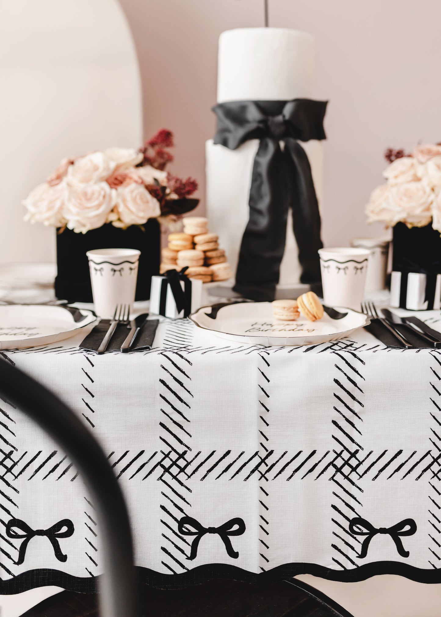 black bows paper table cover with black and white bow cake