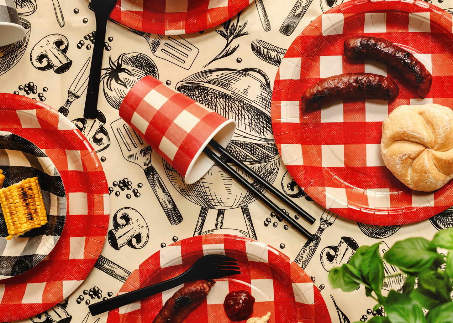 Party table with black reusable straws and red checkered tableware available in Toronto and shipping across Canada