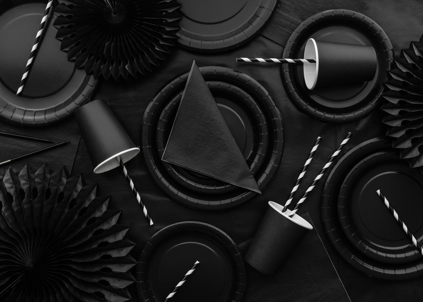 Black party table setup with matching rosette decor available in Toronto and shipping across Canada