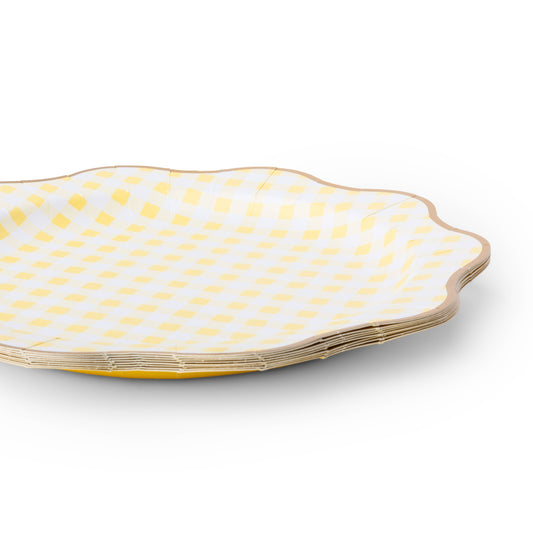 Close-up of butter yellow gingham paper plates with scalloped shape and gold foil edging