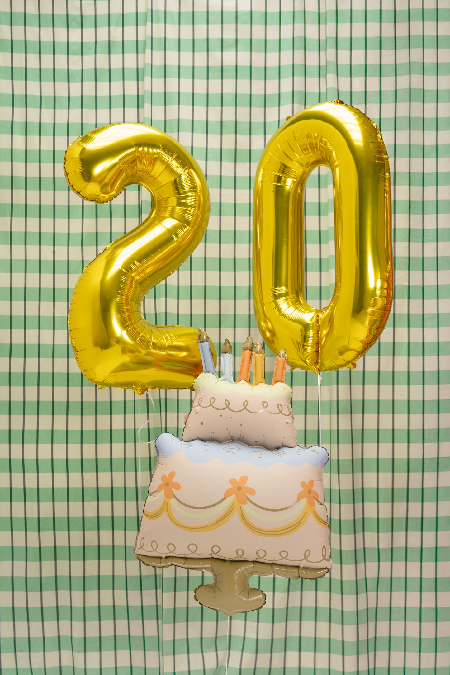 Gold number balloons with cake-shaped foil balloon for birthday celebrations in Toronto.