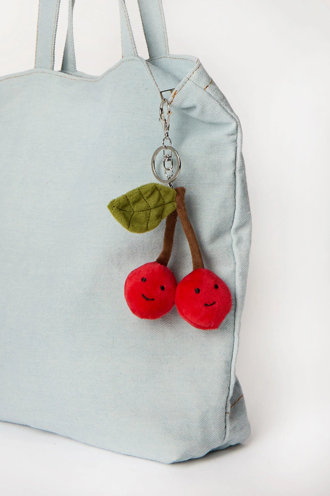 Cherry plush keychain charm clipped onto tote bag available in Toronto and shipping across Canada