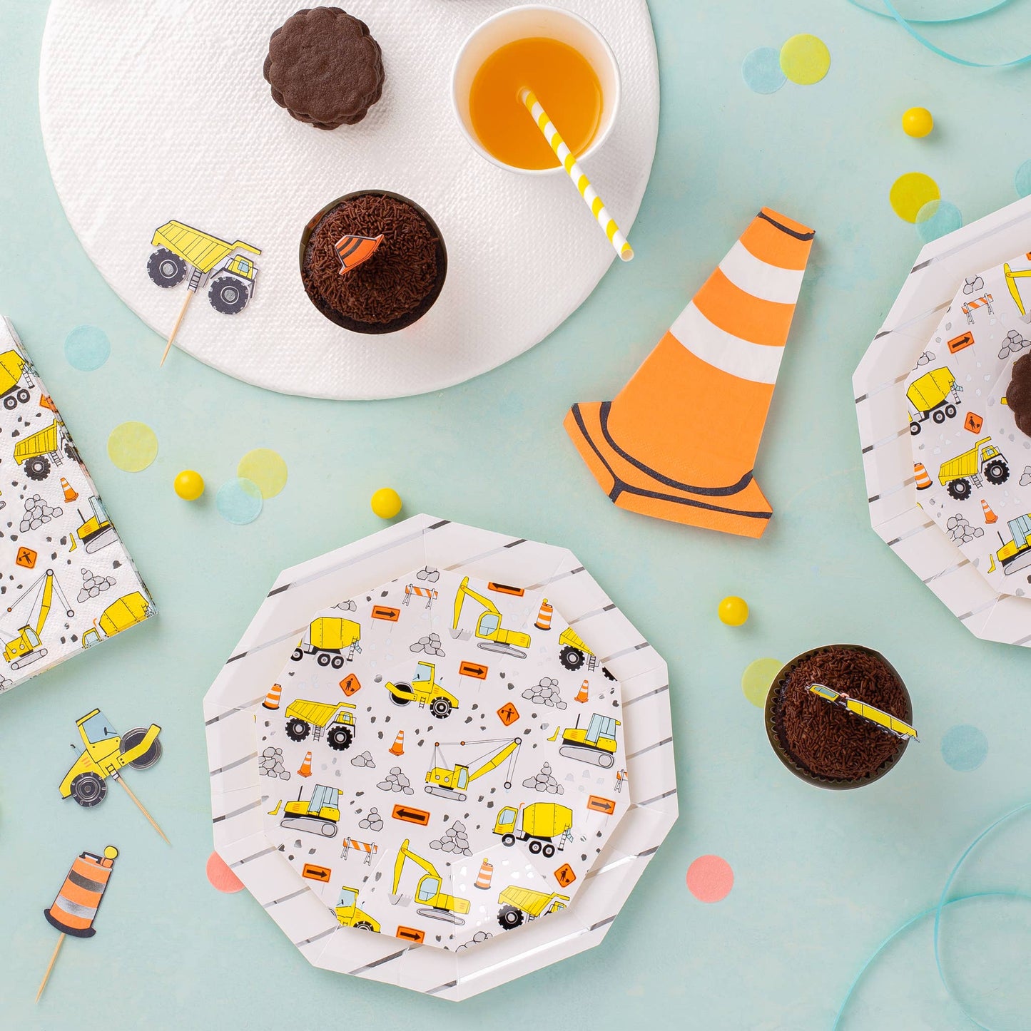 Construction party plates, napkins, and cupcakes with orange cones and trucks styled for kidsβ birthday setup, shipping across Canada.