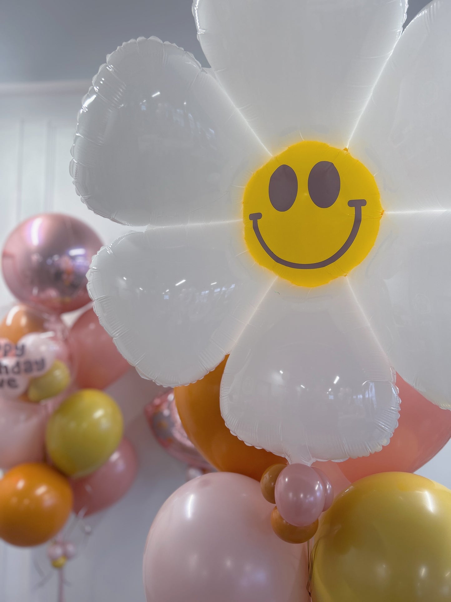 daisy happy face foil balloon