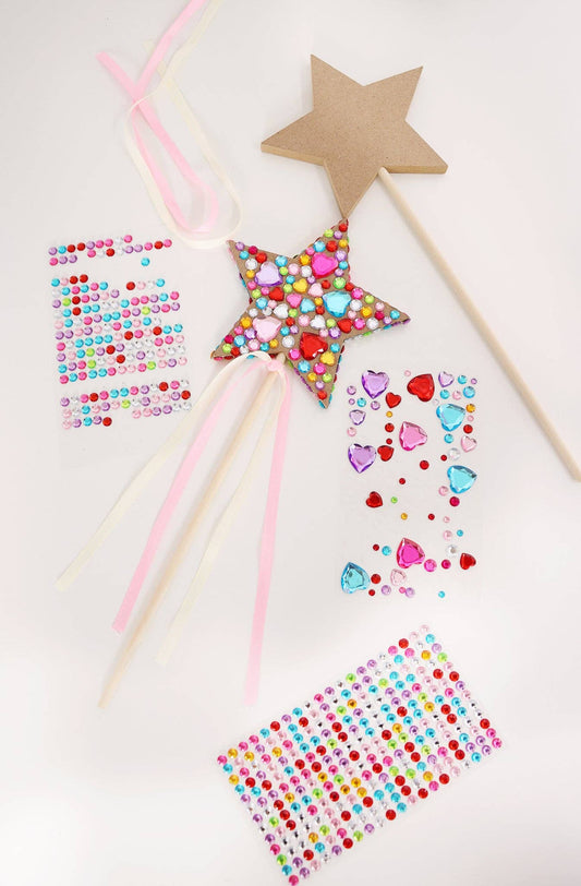 Set of 3 wood star-shaped wands with decorative beads on a white background