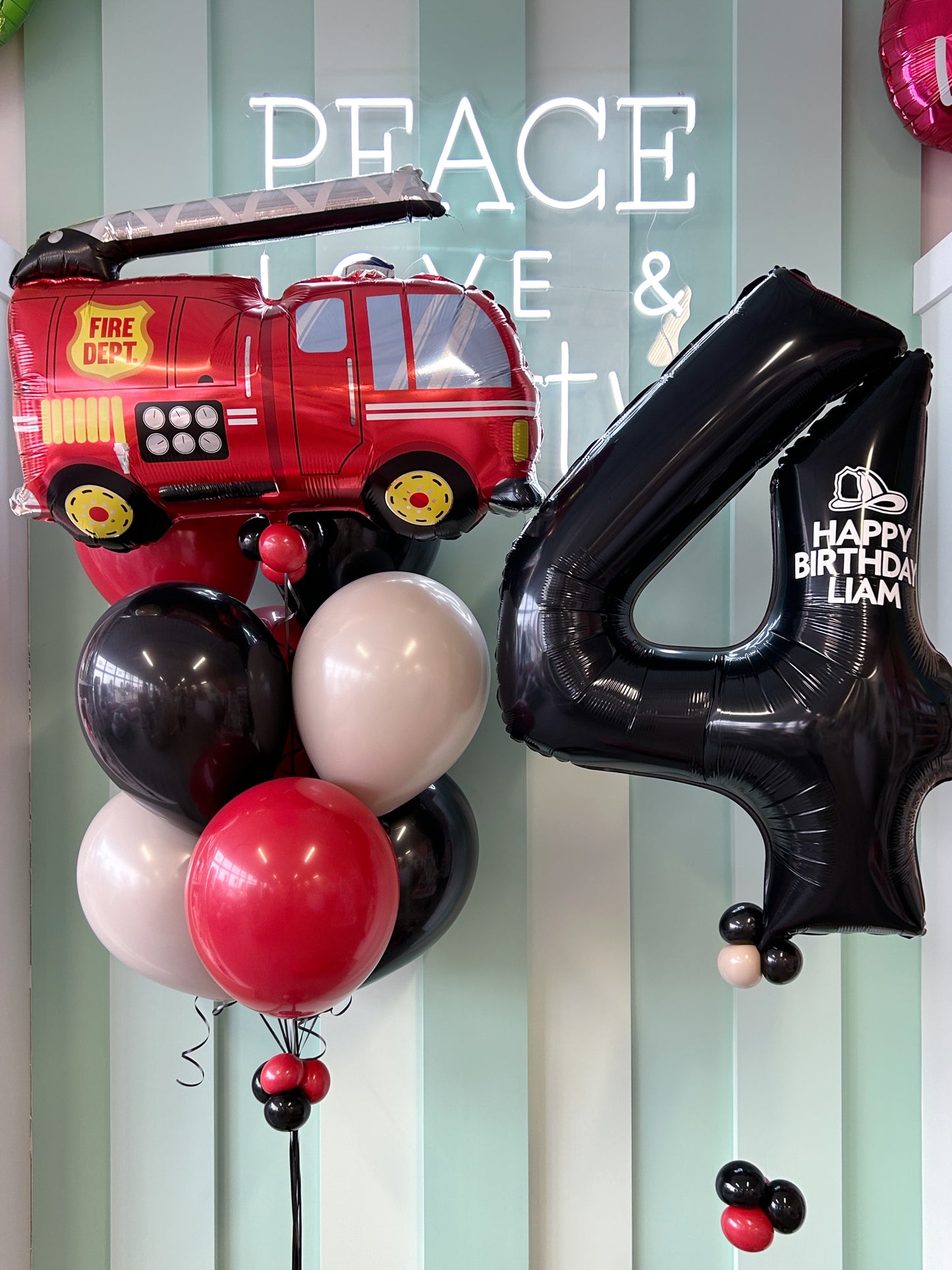 Fire Truck Mini Kid Pop with fire truck foil balloon and jumbo black number balloon styled for a kids birthday celebration in Toronto