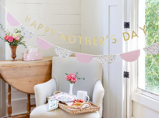 Floral border dinner napkins styled on a Mother’s Day brunch table with pastel plates, florals, and soft spring décor