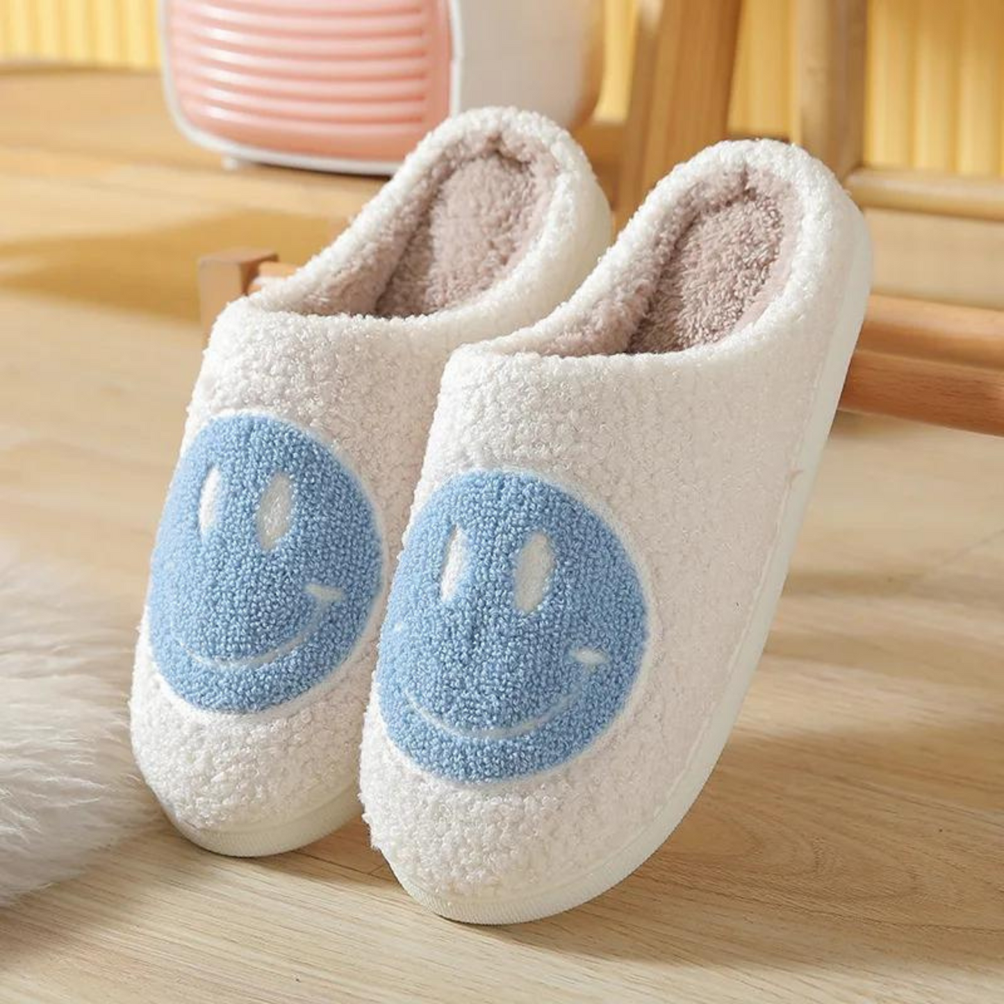 blue and white fuzzy smiley face slippers