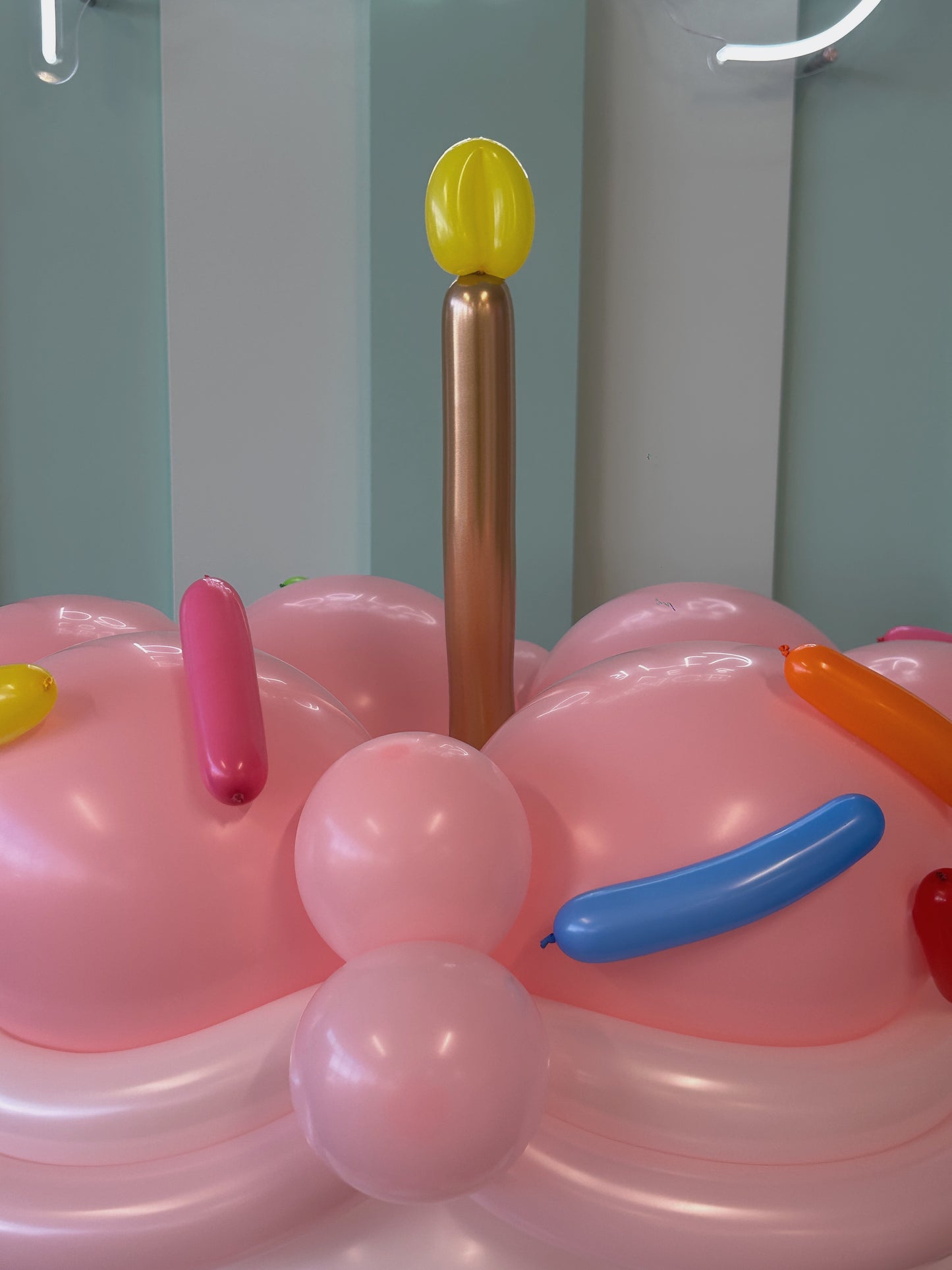 Giant Balloon Birthday Cake candle topper detail with pastel balloon frosting and sculpted balloon candle