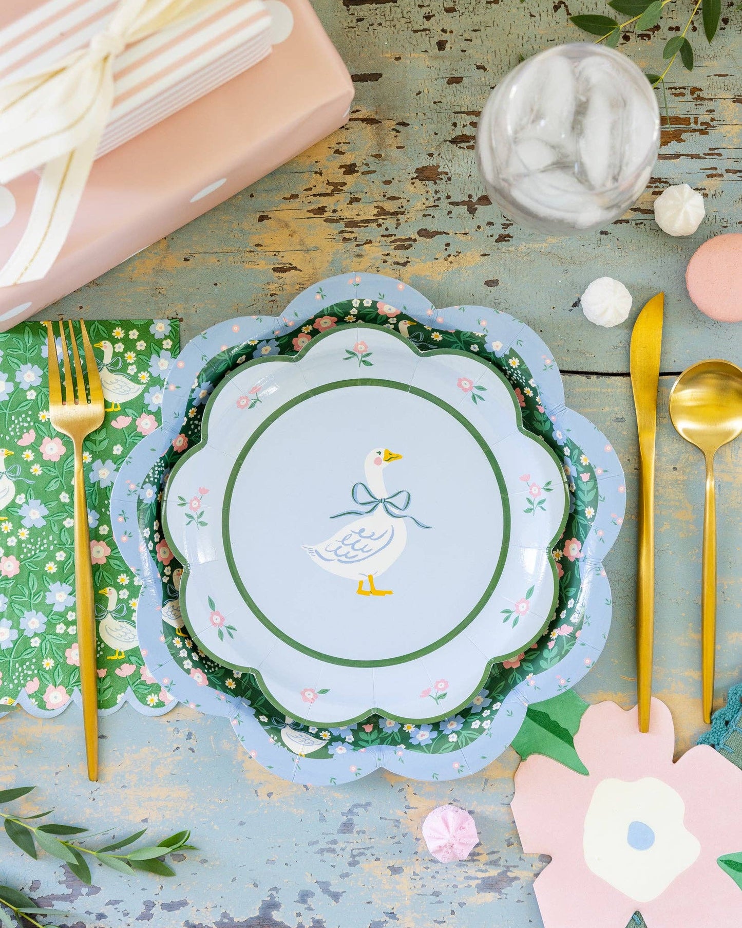 Goose patterned dinner napkins styled with matching plates and gold cutlery, available in Toronto and shipping across Canada