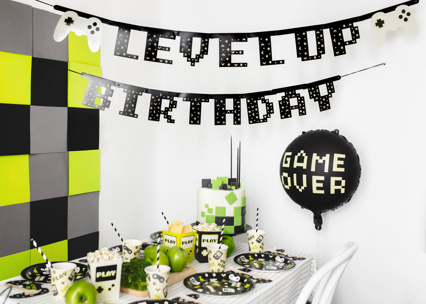 Gamer-themed birthday setup featuring the “Level Up Birthday” banner above a party table, sold in Toronto at Confetti My Party. Ships across Canada.