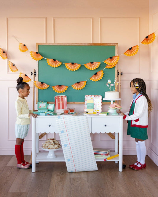 Notebook paper table runner styled with colourful school themed party supplies available at our Toronto party shop.