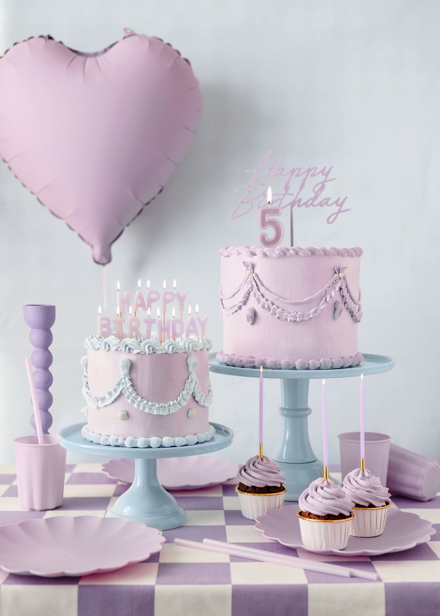 purple happy birthday topper on a pipped sound cake and matching purple party supplies