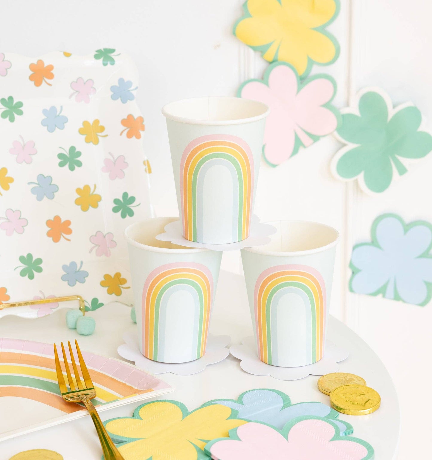 Pastel rainbow paper cups styled on a spring party table with coordinating pastel décor and tableware