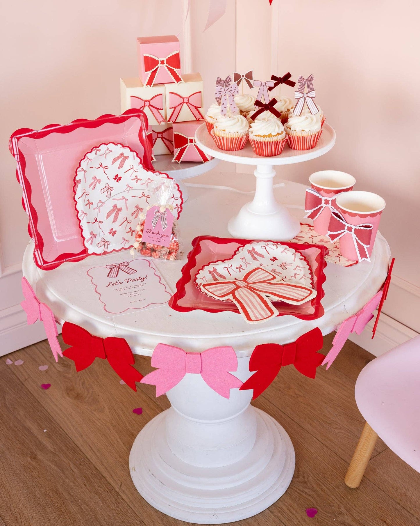 Pink and red bow-shaped napkins styled on a Valentineโs Day dessert table, available in Toronto at Confetti My Party