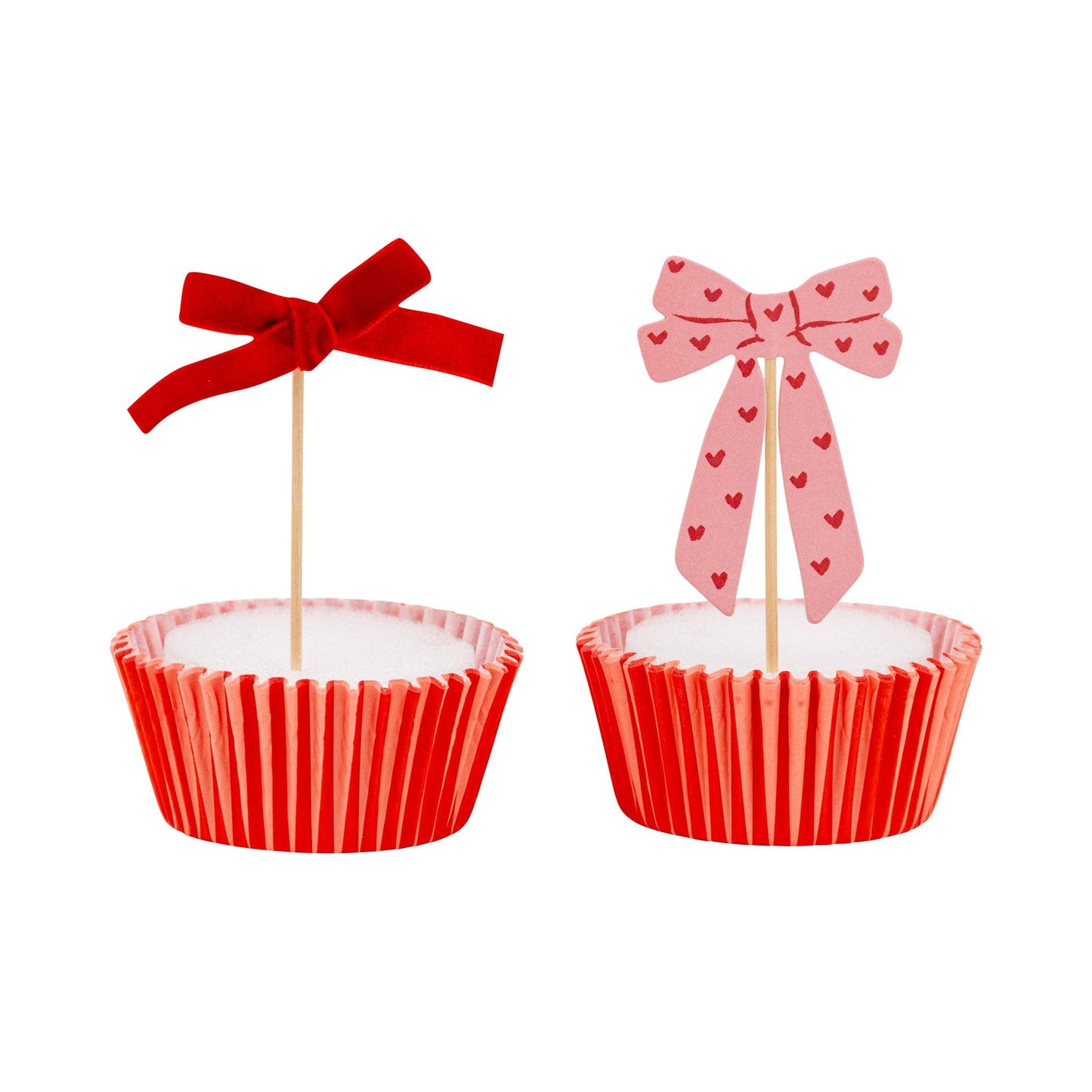 Cupcake topped with a decorative pink bow topper and striped liner, available in Toronto at Confetti My Party