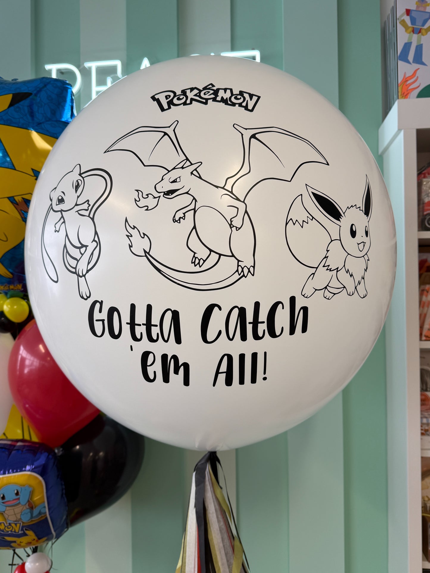 Close-up of jumbo Pokémon birthday balloon with “Gotta Catch ’Em All” design for a Toronto kids birthday celebration.