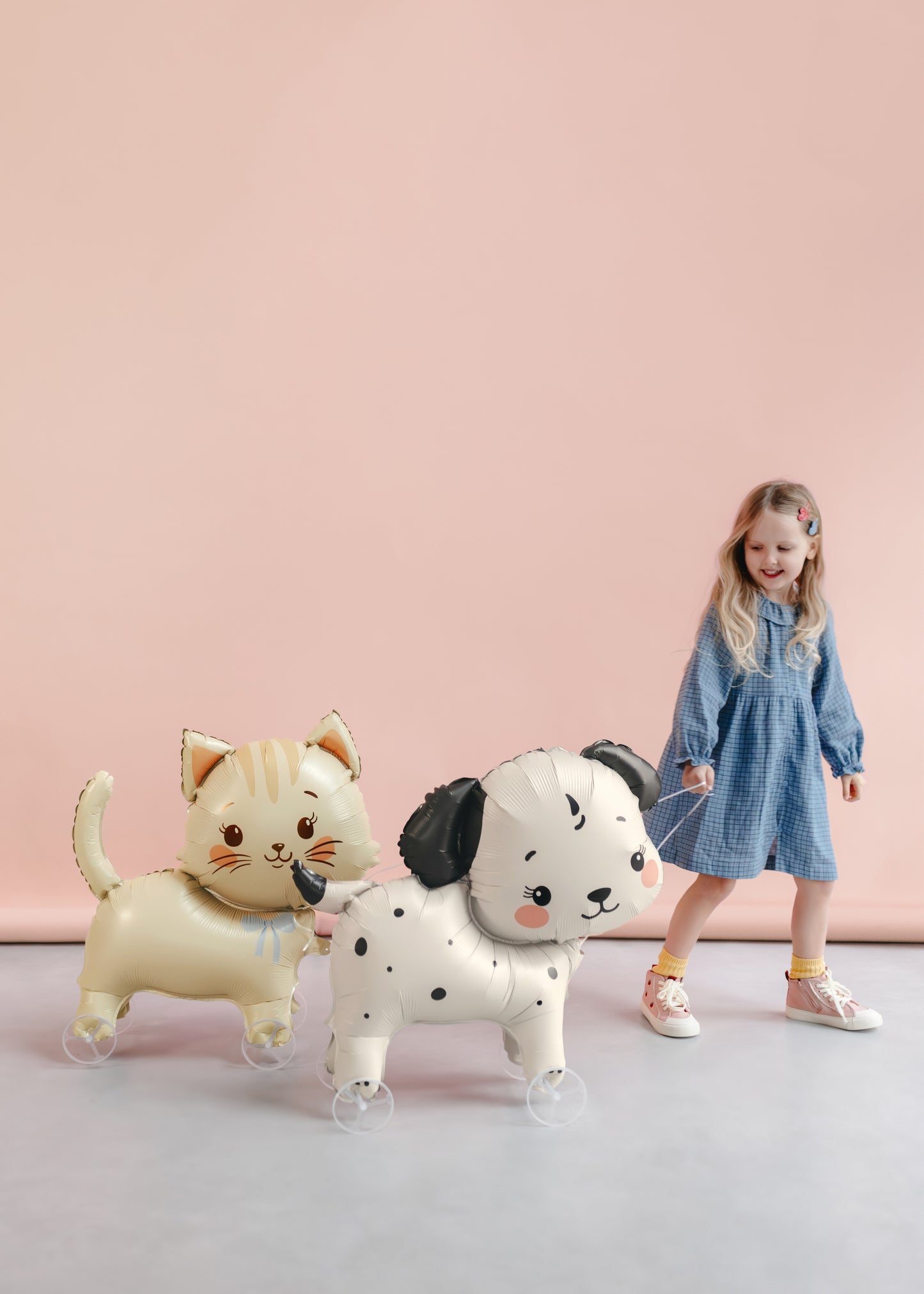Child walking a puppy foil balloon with wheels at a dog themed birthday party, available in Toronto and shipping across Canada.
