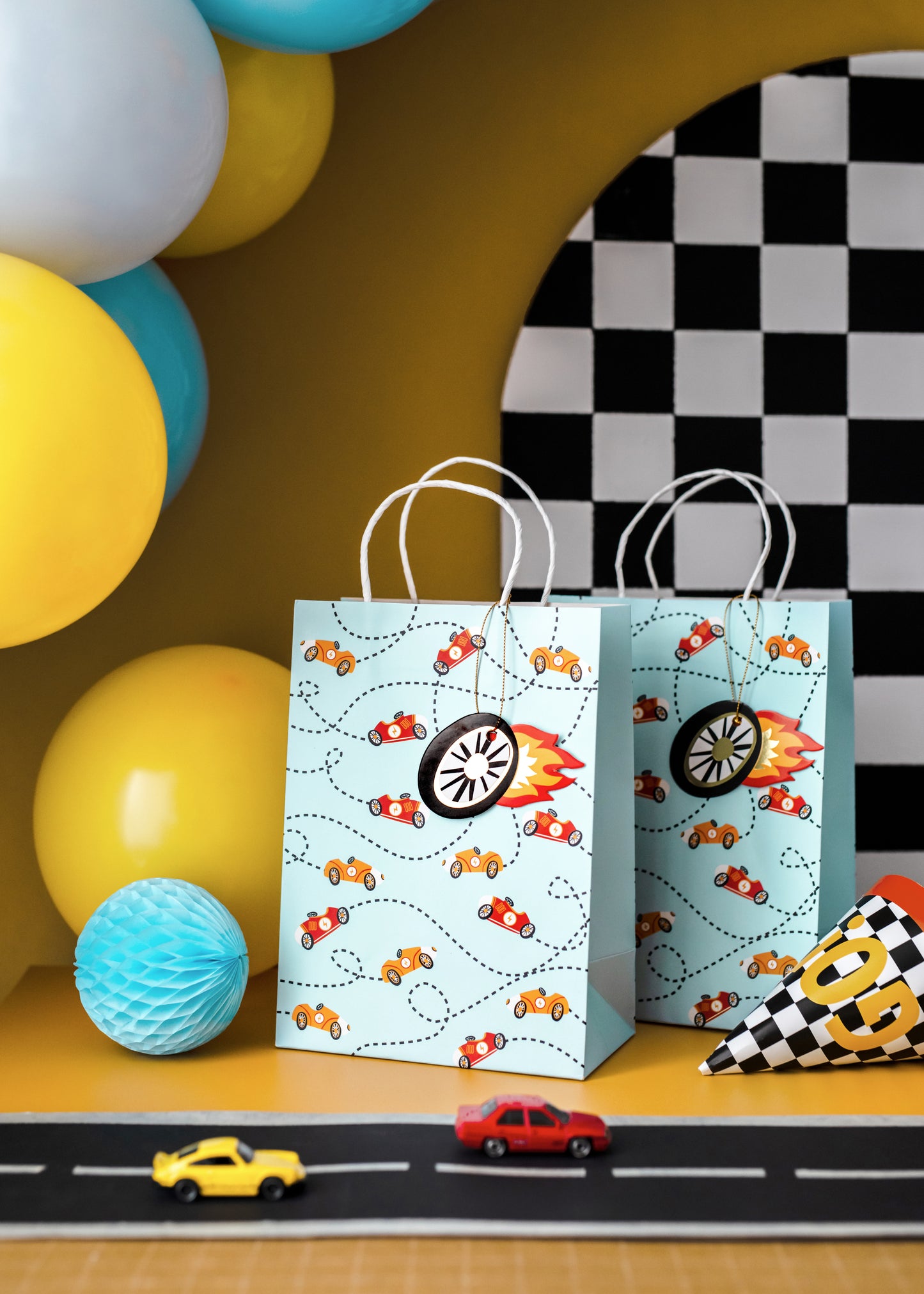 Race car party gift bags styled with balloons and décor, sold in Toronto at Confetti My Party. Ships across Canada.