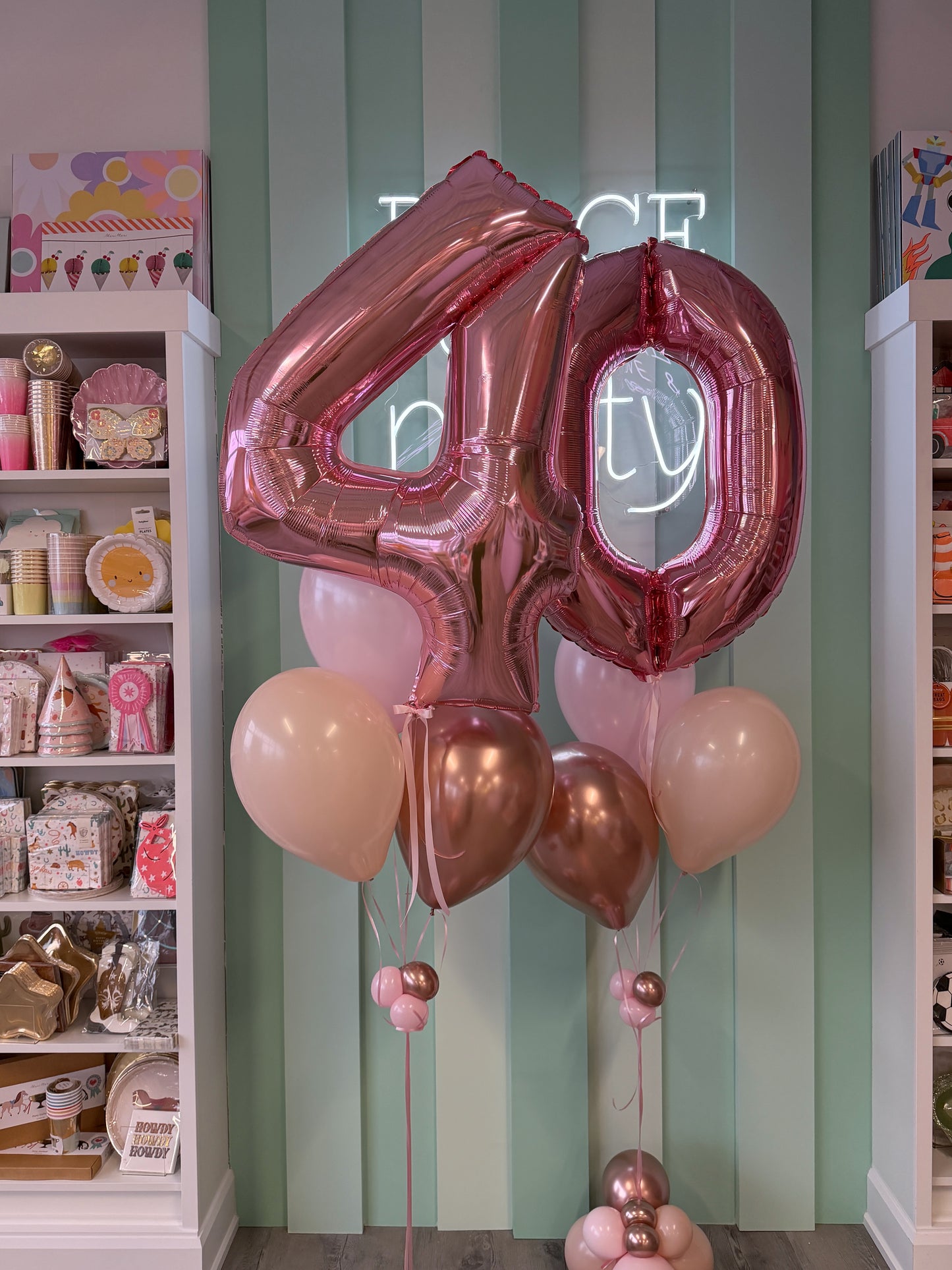 Close-up of rose gold 40 foil number balloons with pink, blush and rose gold helium balloon accents for Toronto birthday parties.