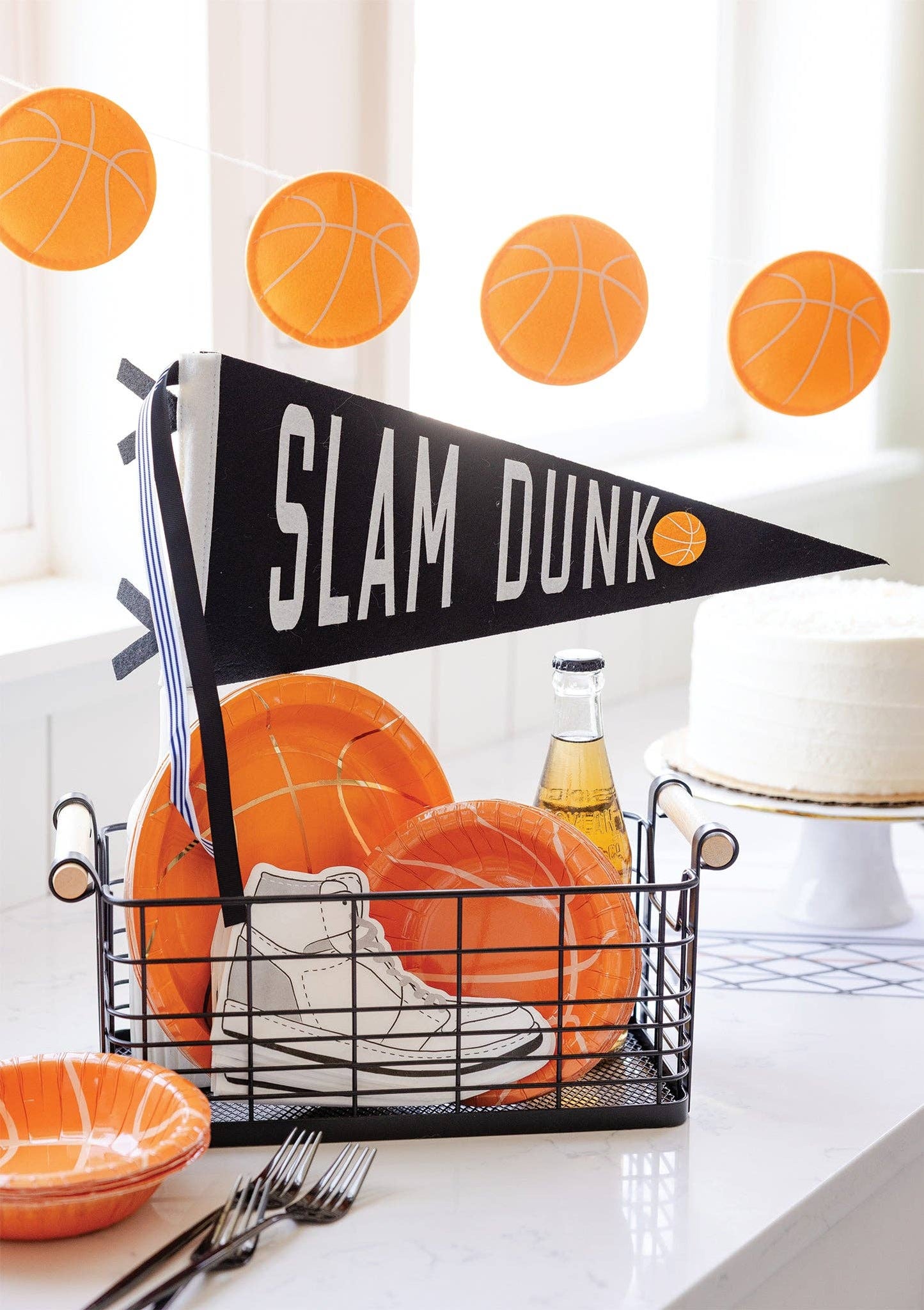 Slam Dunk basketball felt pennant styled with orange basketball party plates and basketball garland.