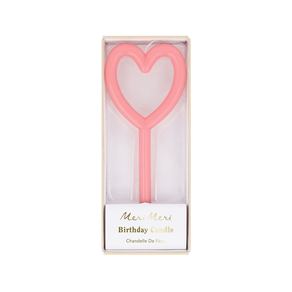 Heart-shaped pink birthday candle in a box with 'Meri Meri' branding on a white background