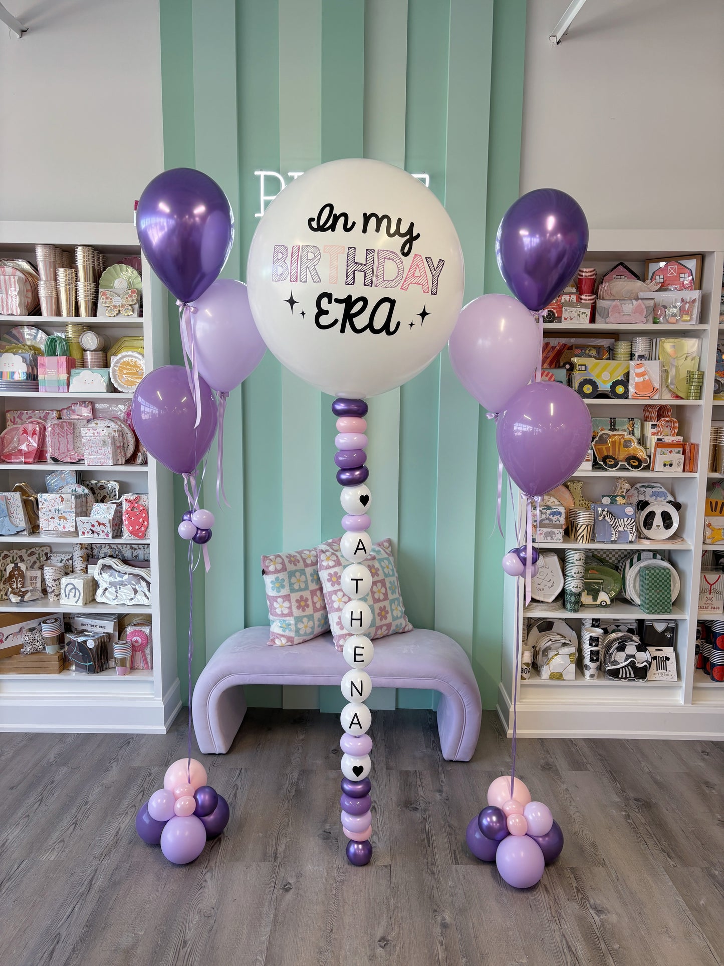 Custom name balloon column spelling “Athena” beneath lavender and purple birthday balloons, styled for Toronto birthday celebrations.