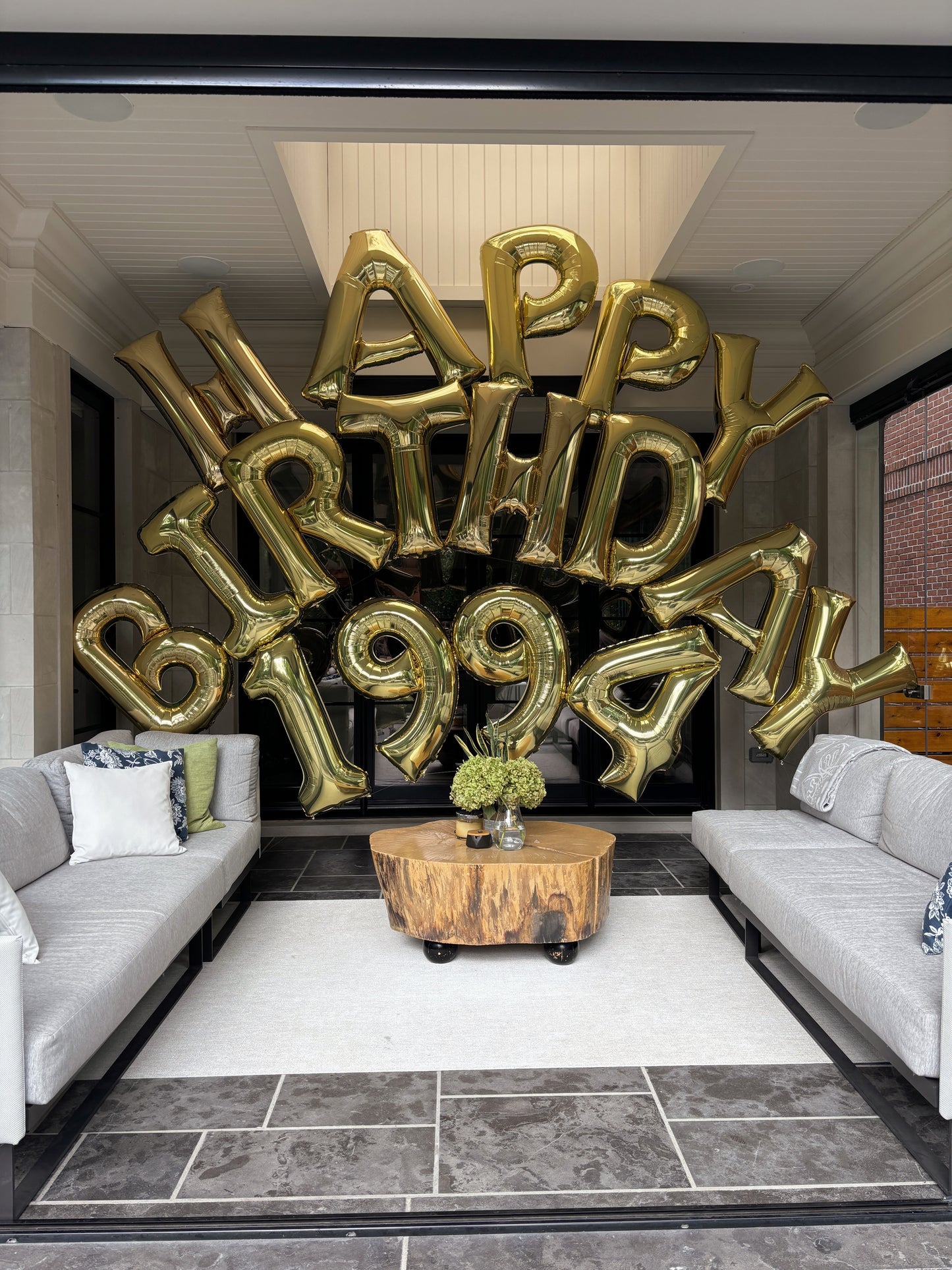 jumbo happy birthday foil letters set up in an arch