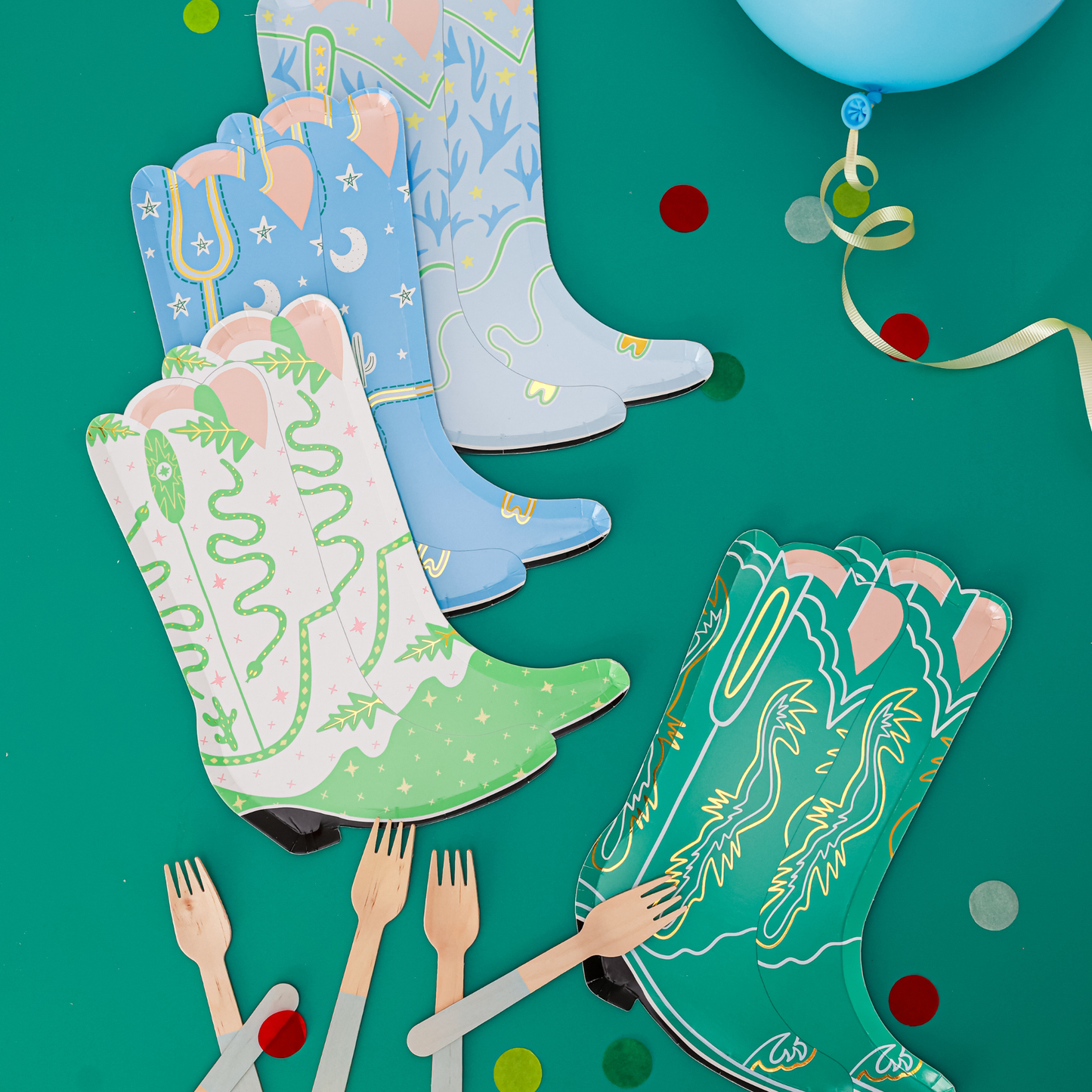 Western-themed party table with Yeehaw large cowboy boot plates in assorted colours, styled with wooden forks, confetti, and balloons, available in Toronto with Canada-wide shipping.