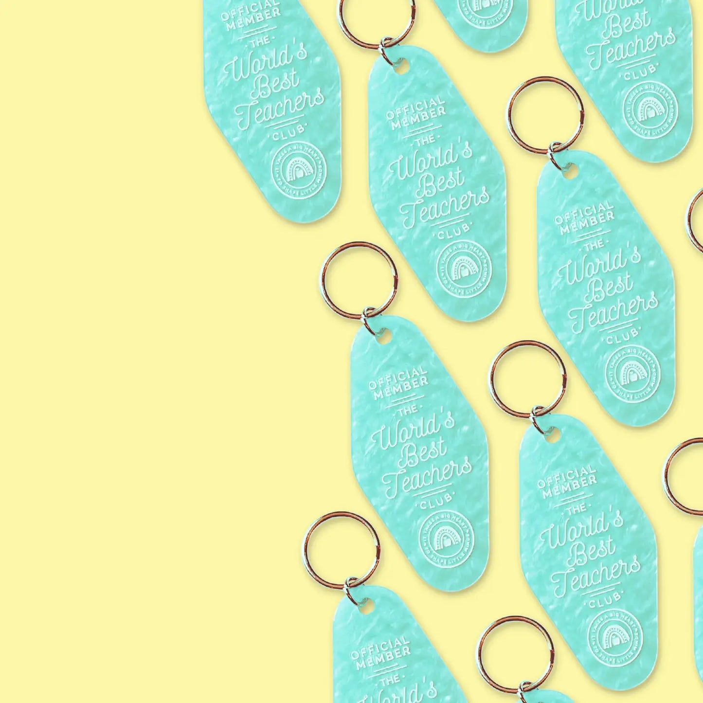 teal motel keychain engraved with "official member the world's best teachers club"