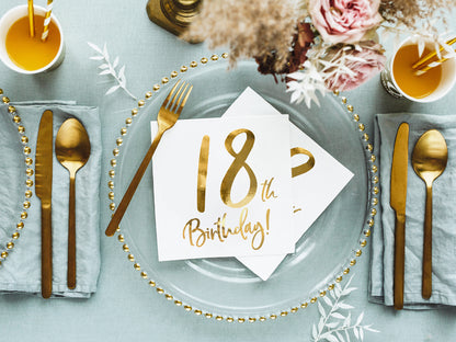 Elegant table setting with white and gold 18th birthday napkins, shipping Canada-wide.