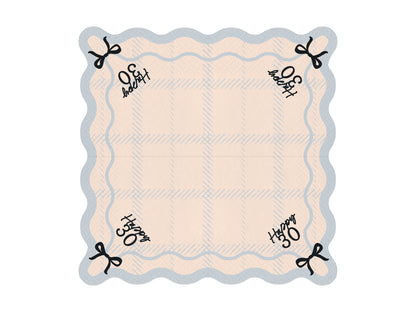 Flat lay of Happy 30 scalloped napkin with pastel plaid pattern and bow detail, ideal for 30th birthday parties in Toronto