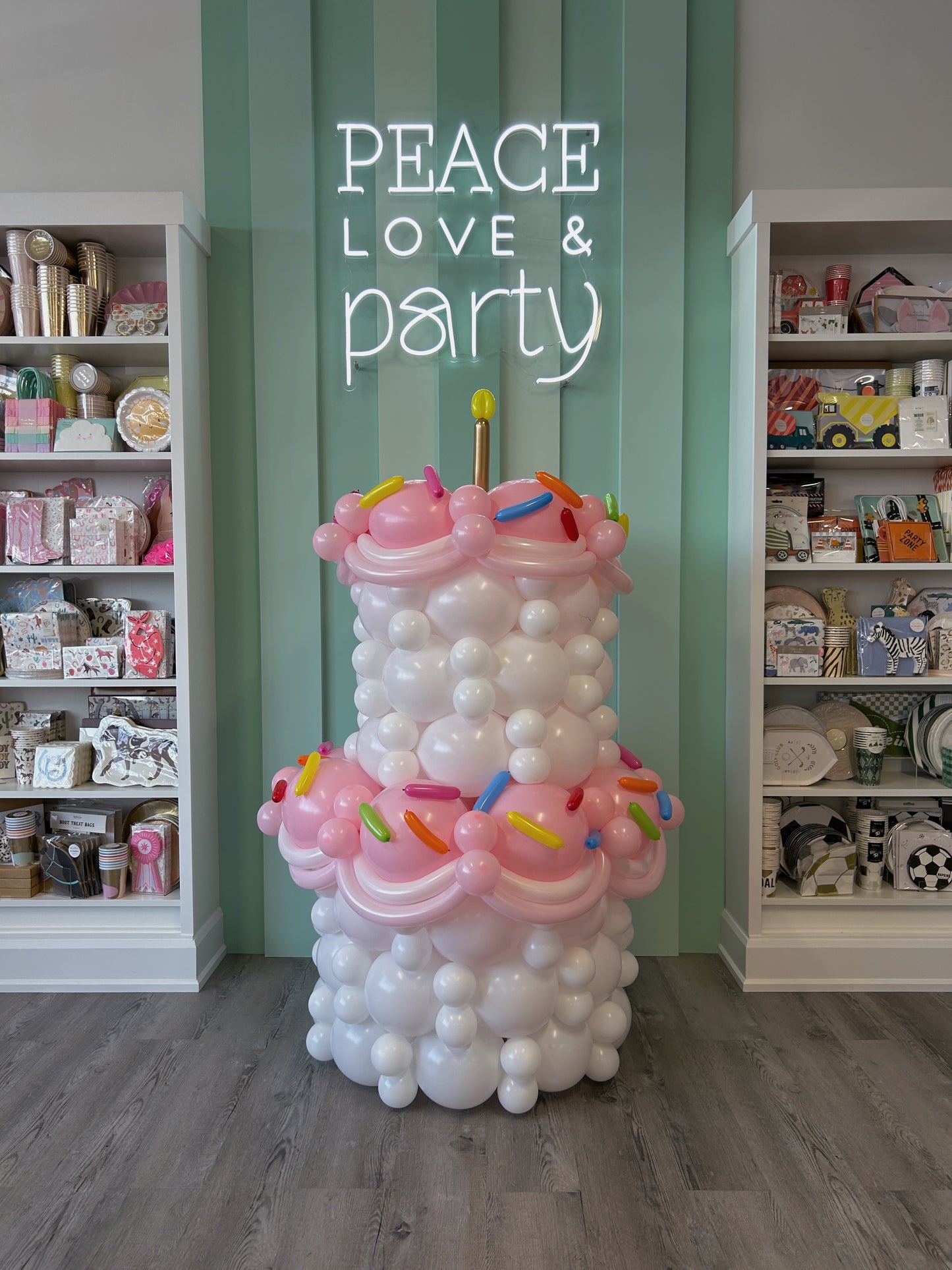 Giant Balloon Birthday Cake featuring a sculpted pastel balloon cake with sprinkle details and candle topper, available in Toronto