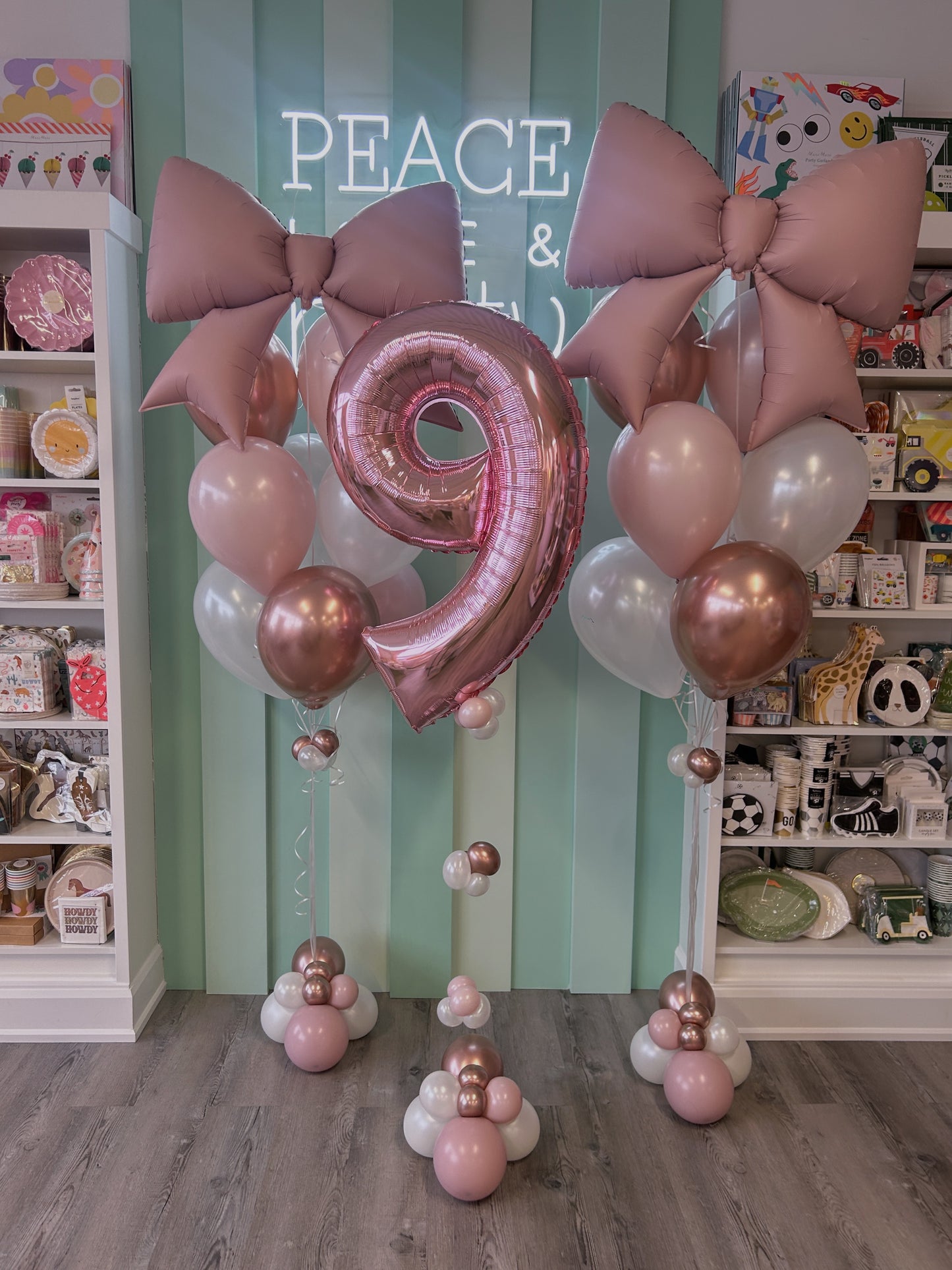 Blush bow balloon bouquets with a rose gold number balloon, styled in soft pink and pearl tones, sold in Toronto at Confetti My Party.