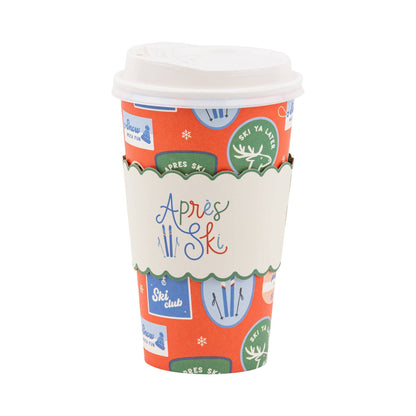 Colourful paper to - go cup with ski-themed designs on a white background