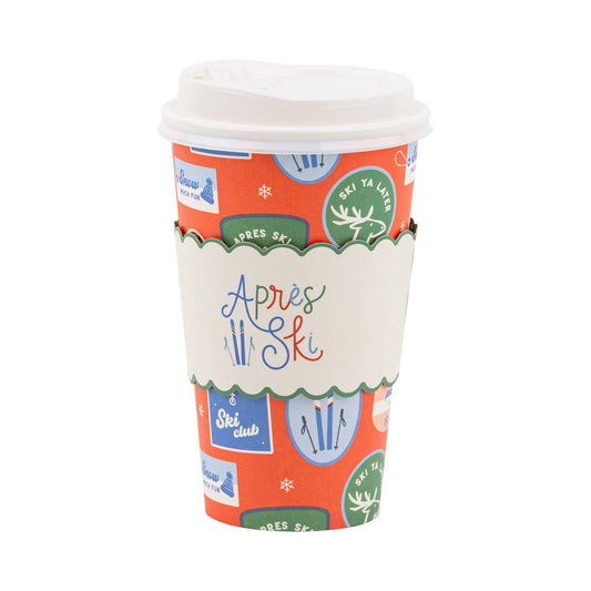 Colourful paper to - go cup with ski-themed designs on a white background