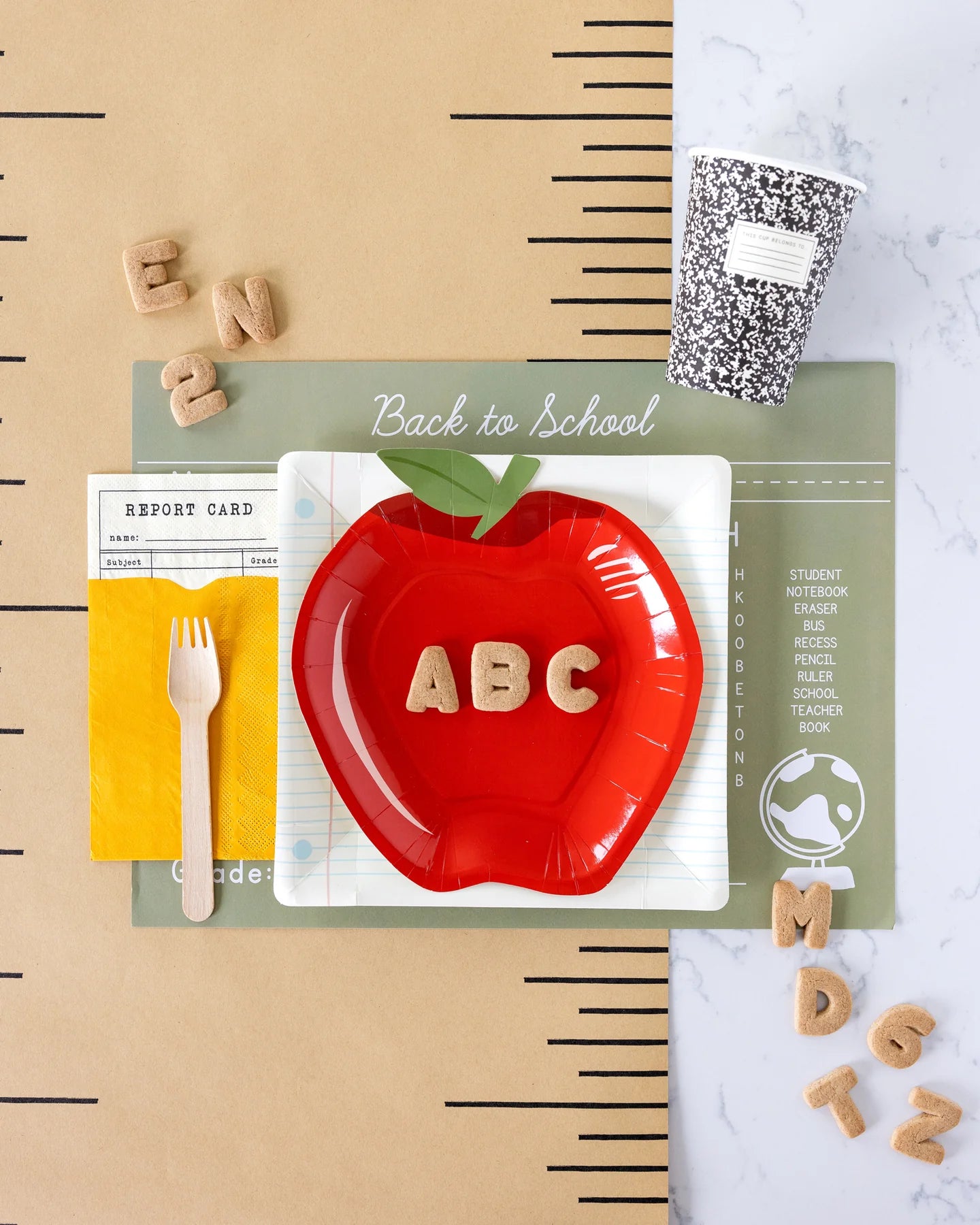 back to school table setting with notebook plate and other party supplies