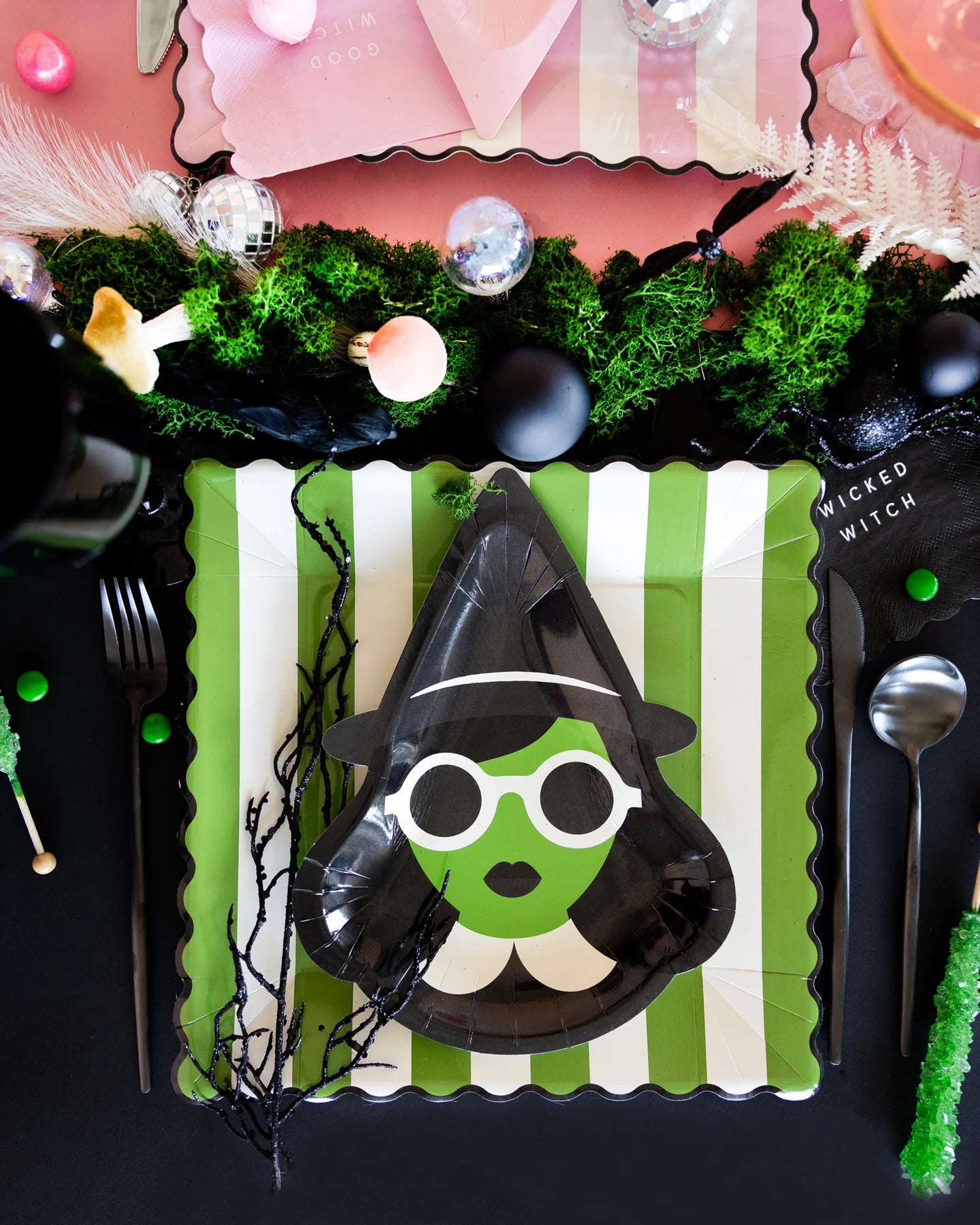 Halloween place setting with Elphaba-inspired witch plate on green striped plate, part of our Wicked collection.
