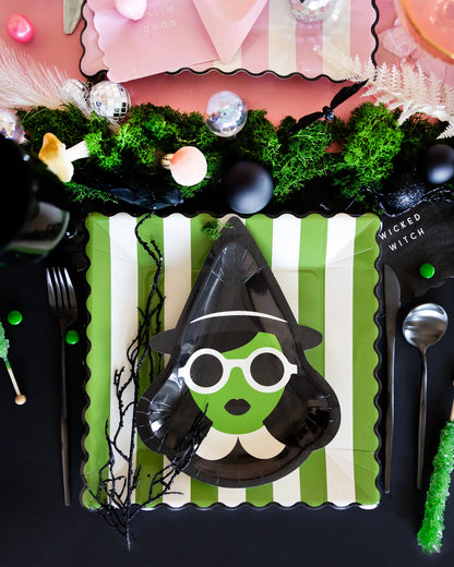 Halloween place setting with Elphaba-inspired witch plate on green striped plate, part of our Wicked collection.