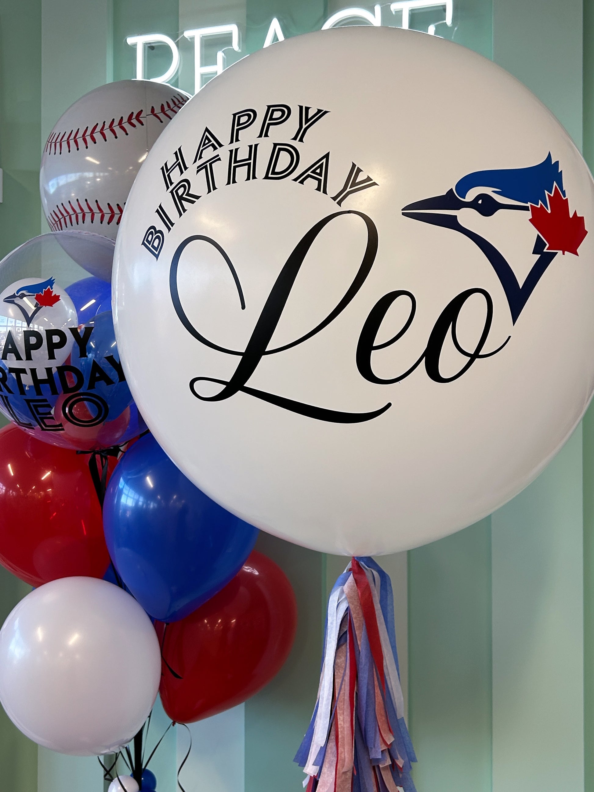 Toronto Blue Jays  balloon display with red, white, and blue balloons and baseball-themed accents, available for pickup in Toronto or GTA delivery