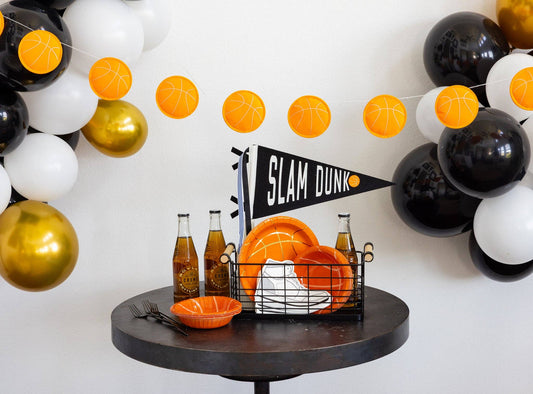 Basketball felt banner styled above a sports birthday party table with basketball-themed plates and decorations available at our Toronto party shop.
