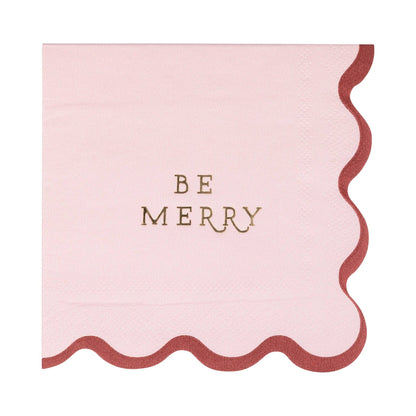 Pink 'Be Merry napkin' with scalloped edges and gold foil.