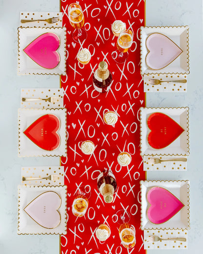 kiss me, be mine, xoxo heart shaped plates in three different shades of red and pink