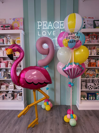 Pink flamingo pool party balloon bundle with beach ball, personalized birthday bubble and colourful balloons in Toronto.