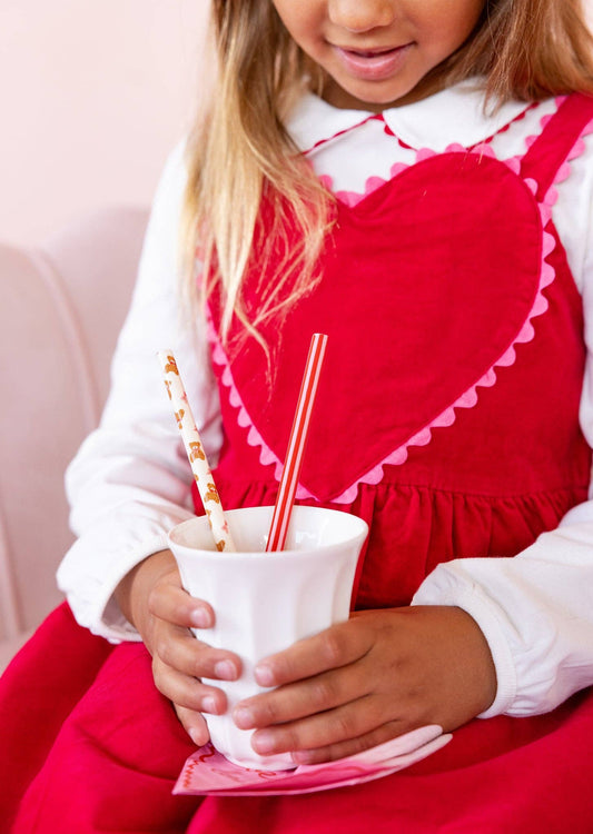 Child holding a drink with Beary Loved reusable straws at a kids party