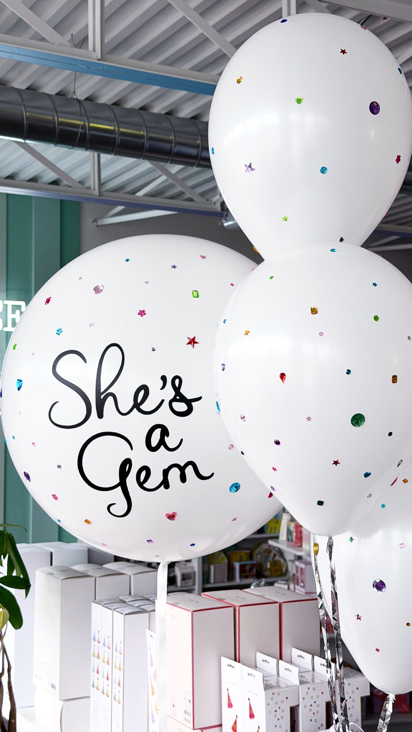 Bedazzled balloon bundle with a personalized white jumbo balloon and colourful gem details, available for birthday celebrations in Toronto.