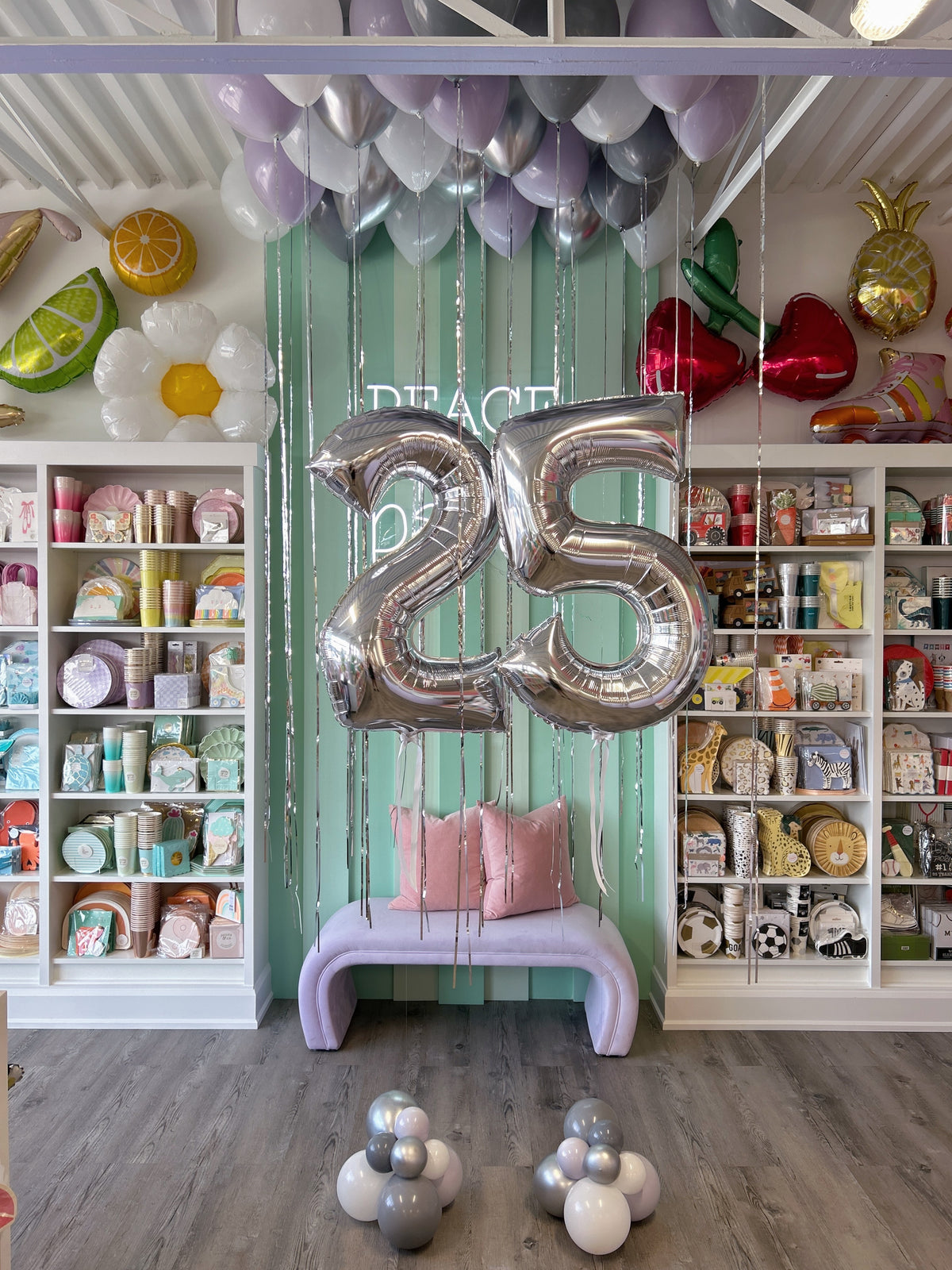 Full birthday balloon display with silver 25 foil numbers, lavender, grey and silver ceiling balloons and matching floor balloon clusters in Toronto.