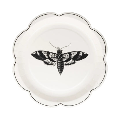Decorative plate with a black and white moth design on a white background